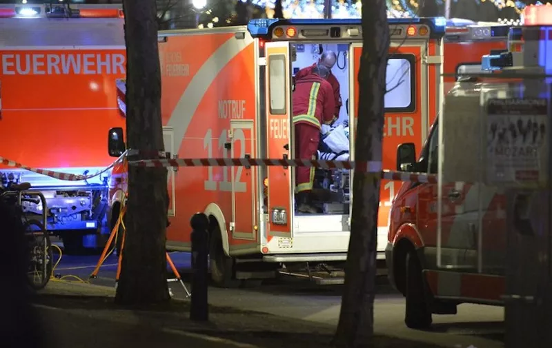 Medics attend to an injured person in an ambulance after a truck crashed into a christmas market at Ged‰chtniskirche church in Berlin, on December 19, 2016 killing at least nine people and injuring at least 50 people. - Ambulances and police rushed to the scene after the driver drove up the pavement of the market in a central square popular with tourists less than a week before Christmas, in a scene reminiscent of the deadly truck attack in Nice. (Photo by Odd ANDERSEN / AFP)