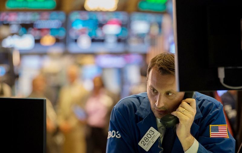 A trader works on the floor of the New York Stock Exchange at the closing bell of the Dow Jones Industrial Average on June 8, 2017 in New York. - Wall Street stocks ended higher Thursday as investors took in stride dramatic testimony from ousted FBI chief James Comey on his firing by President Donald Trump and links to the Russia investigation. The advance was good enough to lift the Nasdaq to a fresh record, while the Dow and S&amp;P 500 eked out modest gains. (Photo by Bryan R. Smith / AFP)