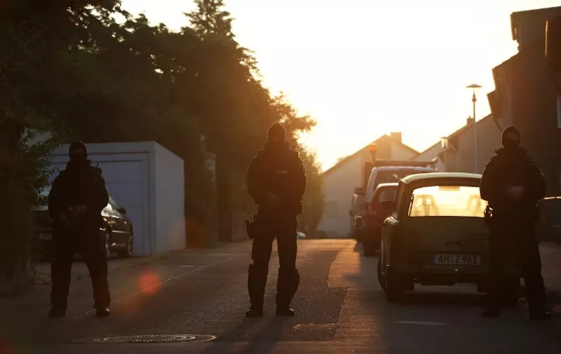Police officers form a cordon on a road leading to a aylum seekers home in the southern German city of Ansbach on 25 July, 2016 
A Syrian migrant set off an explosion at a bar in southern Germany that killed himself and wounded a dozen others late Sunday, authorities said, the third attack to hit Bavaria in a week.
The 27-year-old, who had spent a stint in a psychiatric facility, had intended to target a music festival in the city of Ansbach but was turned away because he did not have a ticket.
 / AFP PHOTO / dpa AND DPA / Daniel Karmann / Germany OUT