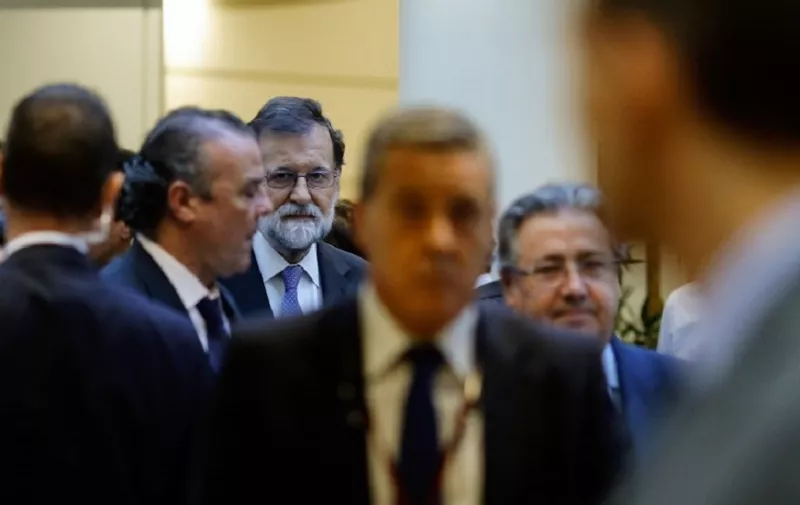 Spain's Prime Minister Mariano Rajoy (3L) arrives for session of the Upper House of Parliament in Madrid on October 27, 2017.
The central government has invoked the never-before-used article 155 of the Constitution, designed to rein in rebel regions, as it seeks to end Catalonia's drive to break from Spain. Spain's upper house is in charge of approving or rejecting the power seizure of the semi-autonomous Catalonia region proposed by Madrid. 
 / AFP PHOTO / OSCAR DEL POZO