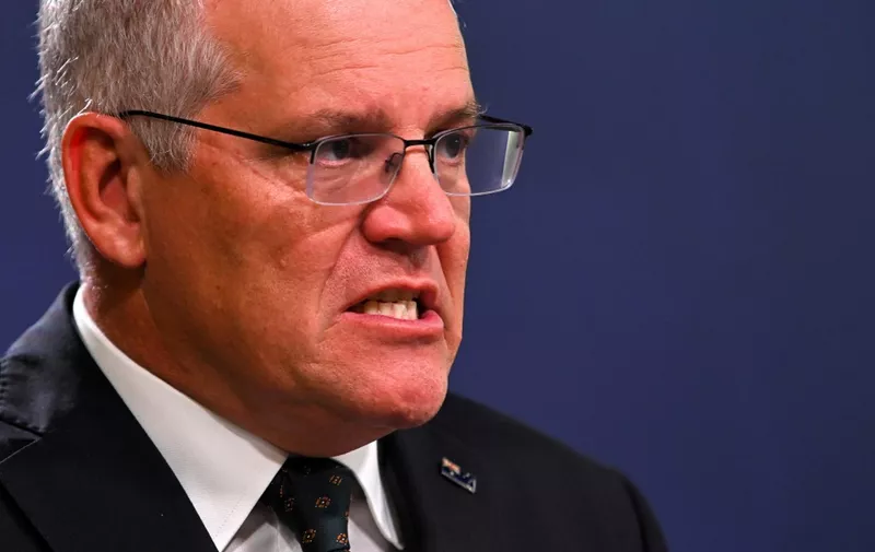 Australia's Prime Minister Scott Morrison speaks to the media to announce sanctions on top Russian officials following the invasion of eastern Ukraine, during a press conference in Sydney on February 23, 2022. (Photo by Steven SAPHORE / AFP)