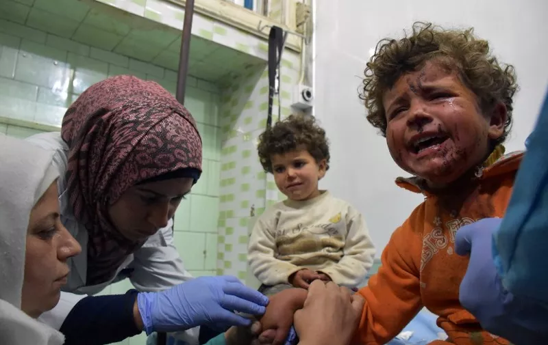 Syrian children, wounded in a suicide car bombing that targeted their buses in Rashidin, west of Aleppo, as they were being evacuated from two besieged government-held towns of Fuaa and Kafraya during an evacuation deal between the regime and rebels, receive treatment at a hospital in the government-held part of Aleppo on April 15, 2017. / AFP PHOTO / George OURFALIAN
