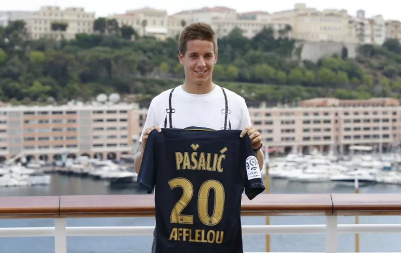 AS Monaco's new Croatian midfielder Mario Pasalic poses with his new jersey during a press conference in Monaco on July 24, 2015.  AFP PHOTO / VALERY HACHE
