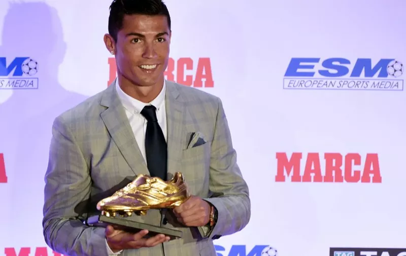 Real Madrid's Portuguese forward Cristiano Ronaldo poses with his fourth European Golden Shoe in Madrid, on October 13, 2015. Cristiano, who ended the season with 48 goals from 35 appearances, won the Golden Shoe in 2008 while he was at Manchester United, in 2011 with Real Madrid and shared it with Luis Suarez last year. AFP PHOTO / JAVIER SORIANO