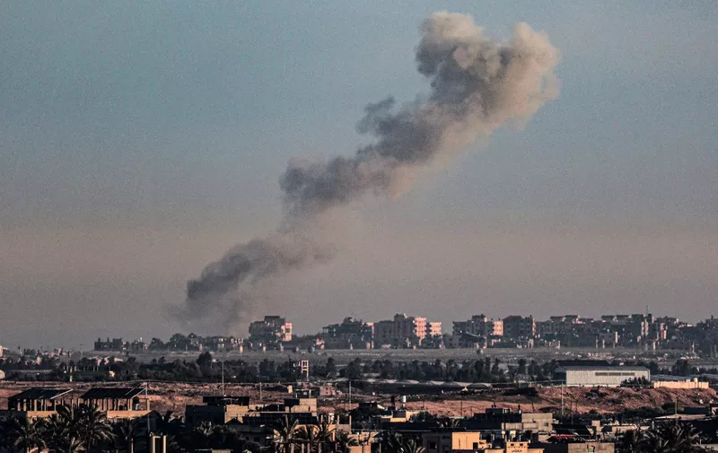 A picture taken from Rafah in the southern Gaza Strip shows smoke rising over buildings in Khan Yunis following Israeli bombardment on February 4, 2024, as fighting continues between Israel and the Palestinian Hamas group. (Photo by Said KHATIB / AFP)