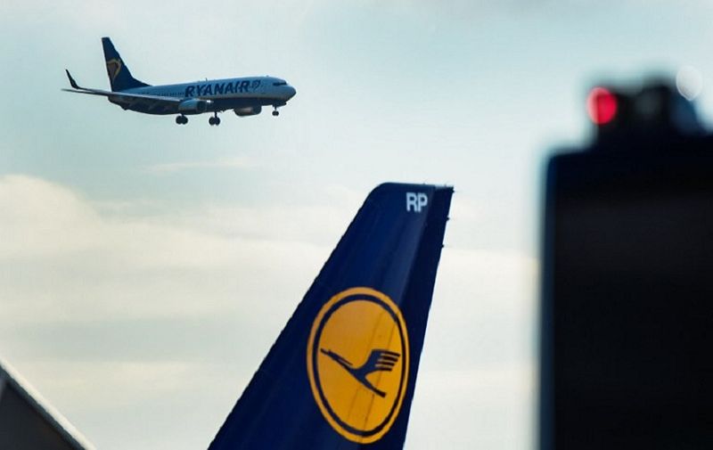 A plane of Irish low-cost airline Ryanair lands at the airport in Frankfurt am Main, western Germany, as in foreground can be seen the logo of German airline Lufthansa on November 2, 2016.
Ryanair said it would base two aircraft at Frankfurt airport, Germany's busiest, serving sun-soaked tourist destinations in Portugal and Spain -- sparking outrage among German competitors. / AFP PHOTO / dpa / Andreas Arnold / Germany OUT