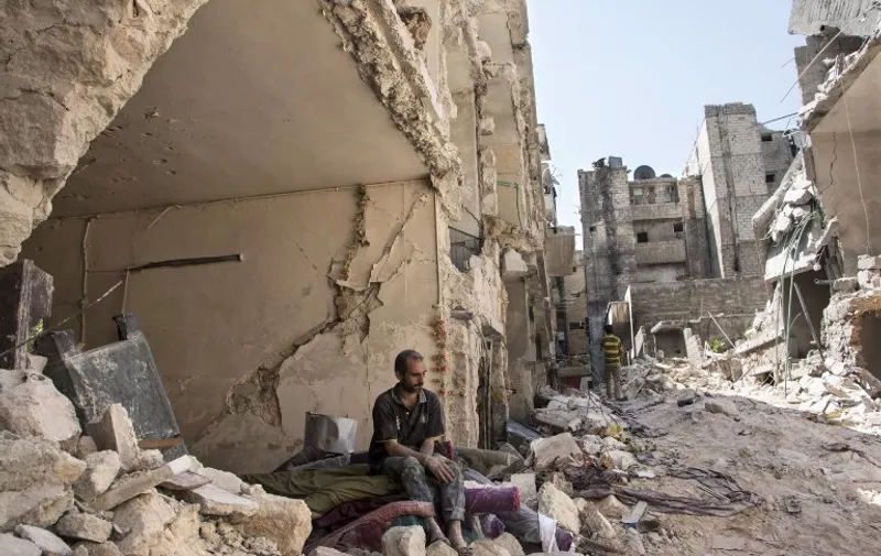 TOPSHOTS
CORRECTING LOCATION
A Syrian man sits in the rubble following a barrel bomb attack the previous day on the rebel-held neighbourhood of al-Mashad in the northern Syrian city of Aleppo on September 17, 2015. Once Syria's economic powerhouse, Aleppo has been ravaged by fighting since the rebels seized the east of the city in 2012, confining government forces to the west. AFP PHOTO / KARAM AL-MASRI