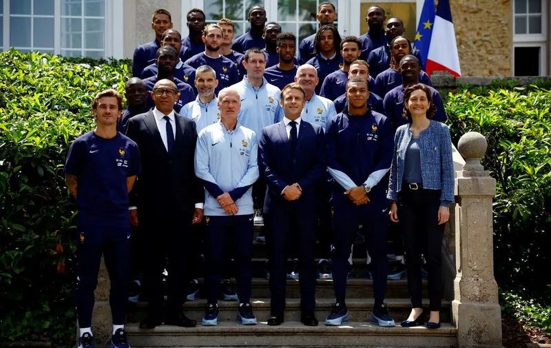 TOPSHOT - French President Emmanuel Macron (front C) poses with French headcoach Didier Deschamps (front C-L), French Football Federation President Philippe Diallo (front 2L), France's Minister for Sports and Olympics Amelie Oudea-Castera (front R) and French football players as part of the team's preparation for the UEFA Euro 2024 European football championships in Clairefontaine-en-Yvelines on June 3, 2024. (Photo by Sarah Meyssonnier / POOL / AFP)