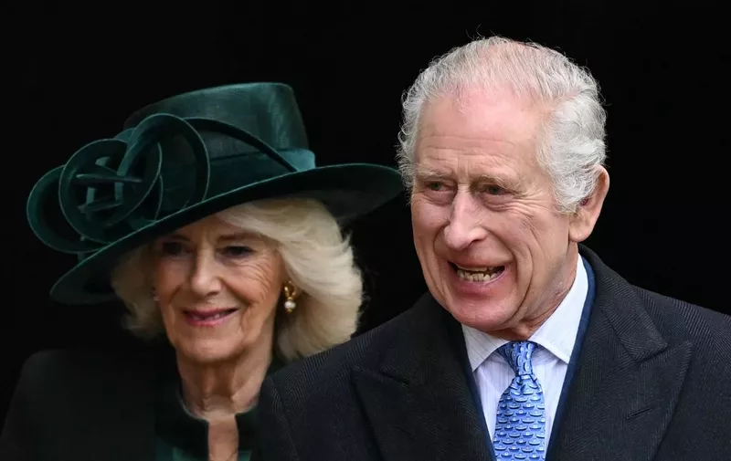 (FILES) Britain's King Charles III (R) and Britain's Queen Camilla reacts as they leave St. George's Chapel, in Windsor Castle, after attending the Easter Mattins Service, on March 31, 2024. British head of state King Charles III will make a limited return to public duties from April 30, 2024, after doctors said they were "very encouraged" by the progress of his treatment for cancer. (Photo by JUSTIN TALLIS / AFP)