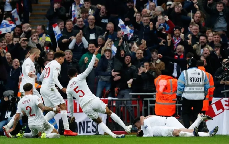 England's striker Harry Kane lies on the floor as England's midfielder Jesse Lingard and teammates celebrate their second goal during the international UEFA Nations League football match between England and Croatia at Wembley Stadium in London on November 18, 2018. (Photo by Adrian DENNIS / AFP) / NOT FOR MARKETING OR ADVERTISING USE / RESTRICTED TO EDITORIAL USE