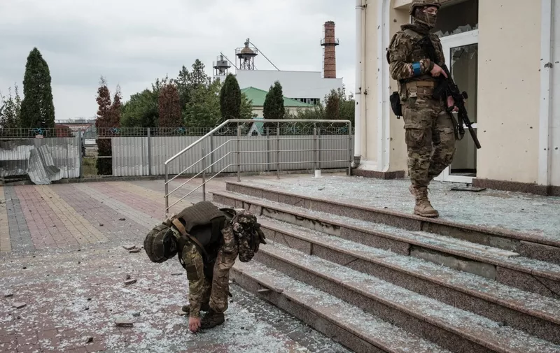 Ukrainian soldiers patrol at the recently retaken railway station in Kupiansk Vuzlovyi, Kharkiv region, on October 2, 2022, amid the Russian military invasion of Ukraine. (Photo by Yasuyoshi CHIBA / AFP)