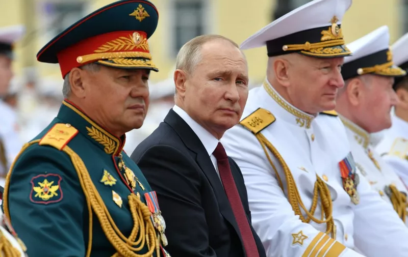Russian President Vladimir Putin (C), Russian Defence Minister Sergei Shoigu (L) and Commander-in-Chief of the Russian Navy, Admiral Nikolai Yevmenov (R) attend the Navy Day parade in St.Petersburg on July 25, 2021. (Photo by Alexey NIKOLSKY / SPUTNIK / AFP)