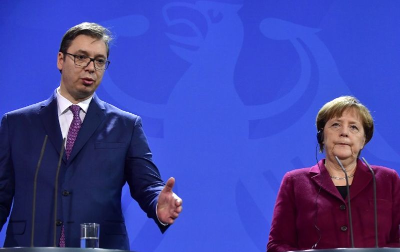 German Chancellor Angela Merkel (R) and Serbian Prime Minister Alexander Vucic  attend a press conference on March 14, 2017 at the chancellery in Berlin. / AFP PHOTO / John MACDOUGALL