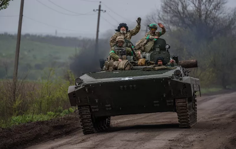 Ukrainian servicemen ride in a BMP infantry fighting vehicle near the town of Bakhmut, in the Donetsk region, on April 28, 2023, amid the Russian invasion on Ukraine. (Photo by Dimitar DILKOFF / AFP)