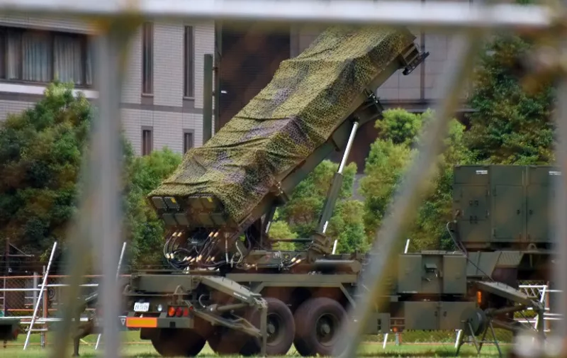 A Japanese Self-Defence Force Patriot Advanced Capability-3 (PAC-3) missile interceptor is deployed outside the Defence Ministry headquarters in Tokyo on August 11, 2017. 
The Defence Ministry is considering deploying PAC-3 interceptor batteries in Japan's western regions in response to plans by North Korea to target the US territory of Guam, according to local media reports on August 10. / AFP PHOTO / Kazuhiro NOGI