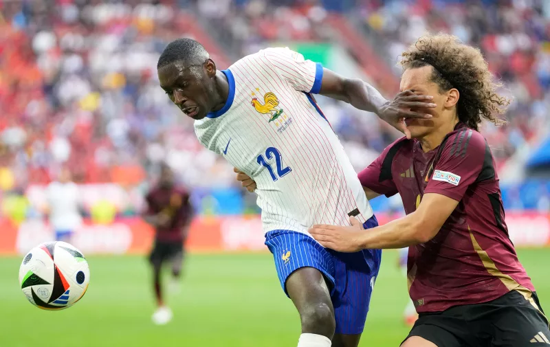Randal Kolo Muani of France fights for the ball with Belgium's Wout Faes, right, during a round of sixteen match between France and Belgium at the Euro 2024 soccer tournament in Duesseldorf, Germany, Monday, July 1, 2024. (AP Photo/Darko Vojinovic)