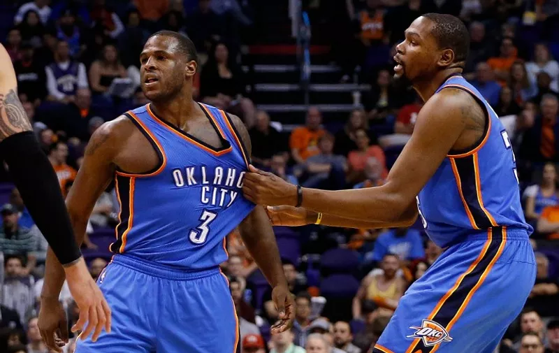 PHOENIX, AZ - FEBRUARY 08: Dion Waiters #3 of the Oklahoma City Thunder is held back by Kevin Durant #35 after a collision with the Phoenix Suns during the second half of the NBA game at Talking Stick Resort Arena on February 8, 2016 in Phoenix, Arizona. The Thunder defeated the Suns 122-106. NOTE TO USER: User expressly acknowledges and agrees that, by downloading and or using this photograph, User is consenting to the terms and conditions of the Getty Images License Agreement.   Christian Petersen/Getty Images/AFP