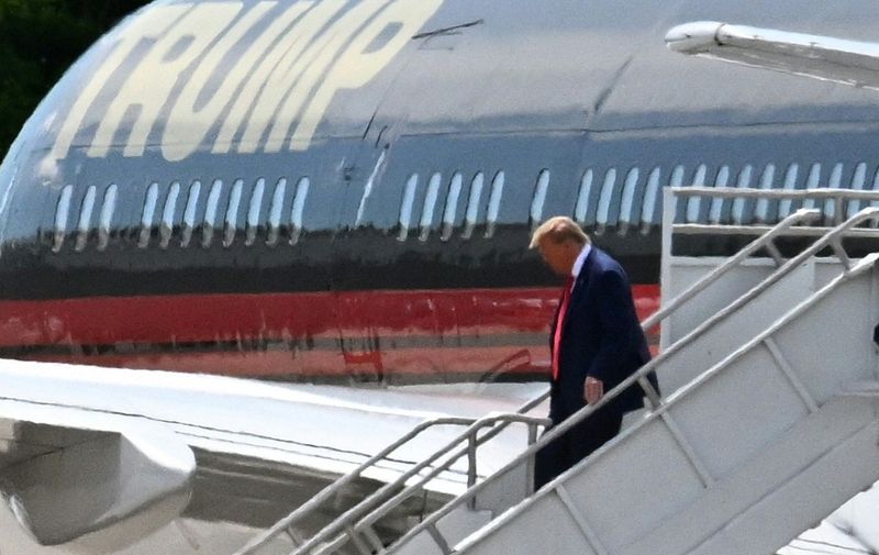 Former US President Donald Trump disembarks "Trump Force One" at Miami International Airport in Miami, Florida, on June 12, 2023. Trump is expected to appear in court in Miami on June 13 for an arraignment regarding 37 federal charges, including violations of the Espionage Act, making false statements, and conspiracy regarding his mishandling of classified material after leaving office. (Photo by CHANDAN KHANNA / AFP)