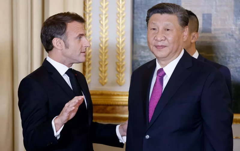 France's President Emmanuel Macron (L) speaks with Chinese President Xi Jinping during an official state dinner as part of the Chinese president's two-day state visit to France, at the Elysee Palace in Paris, on May 6, 2024. The French president hosts his Chinese counterpart for a state visit on May 6, 2024, seeking to persuade the Chinese leader to shift positions over Russia's invasion of Ukraine and also imbalances in global trade. (Photo by Ludovic MARIN / POOL / AFP)