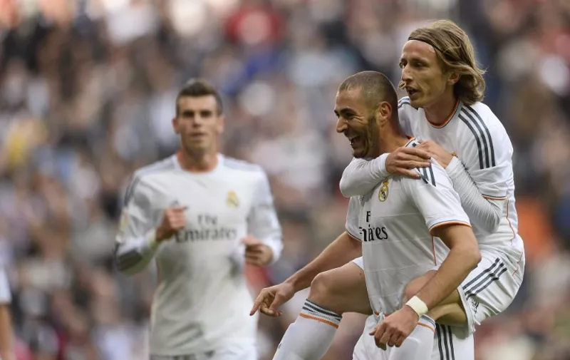 Real Madrid's French forward Karim Benzema (C) celebrates with Real Madrid's Croatian midfielder Luka Modric after scoring during the Spanish league football match Real Madrid vs Real Sociedad on November 9, 2013 at the Santiago Bernabeu stadium in Madrid.   AFP PHOTO / PIERRE-PHILIPPE MARCOU