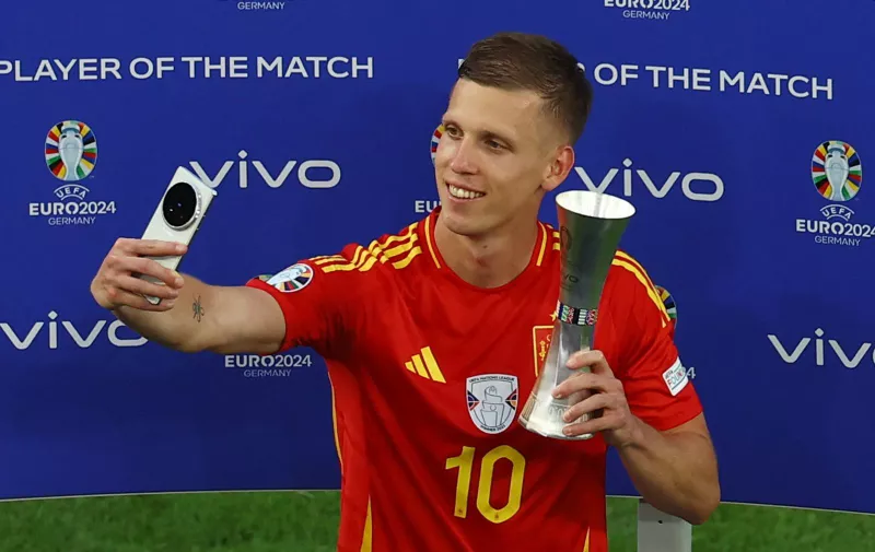 Soccer Football - Euro 2024 - Quarter Final - Spain v Germany - Stuttgart Arena, Stuttgart, Germany - July 5, 2024 Spain's Dani Olmo takes a selfie with the player of the match trophy after the match REUTERS/Leonhard Simon