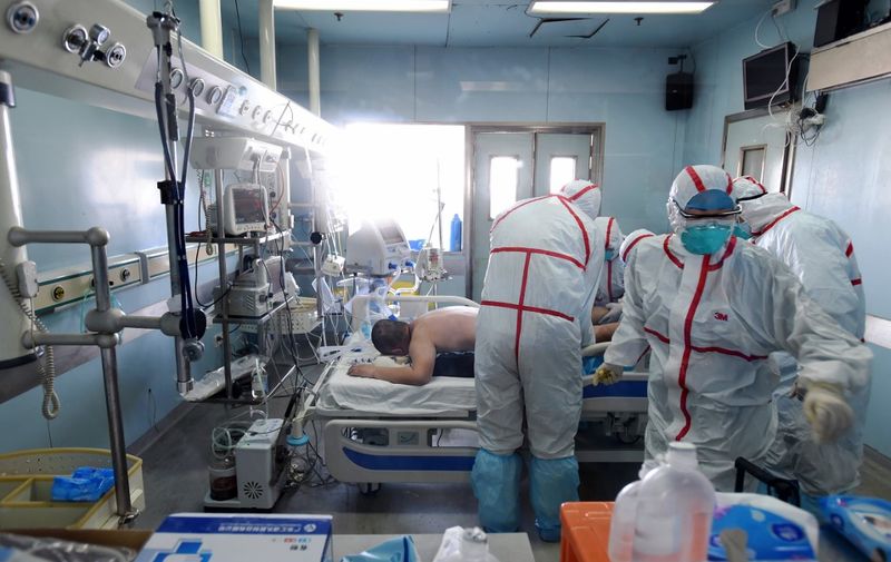 This photo taken on February 12, 2017 shows an H7N9 bird flu patient being treated in a hospital in Wuhan, central China's Hubei province. - A number of provinces in China have stepped up efforts to prevent H7N9 avian flu following reports of scattered human cases of the virus, state media reported. (Photo by STR / AFP) / China OUT