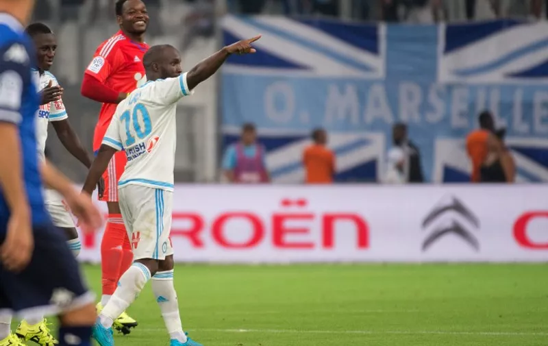 Marseille's French midfielder Lassana Diarra celebrates after scoring a goal during the French L1 football match Olympique de Marseille vs Troyes on August 23, 2015 at the Velodrome stadium in Marseille, southern France. AFP PHOTO / BERTRAND LANGLOIS