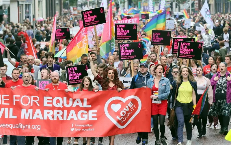 Gay rights campaigners take part in a march through Belfast on July 1, 2017 to protest against the ban on same-sex marriage. (Photo by Paul FAITH / AFP)