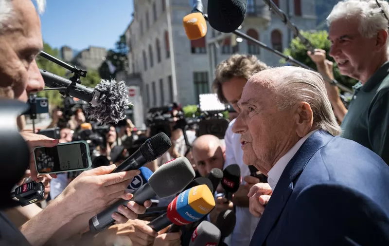 Former FIFA president Sepp Blatter speaks to the press as he leaves Switzerland's Federal Criminal Court after the verdict of his trial over a suspected fraudulent payment, in the southern Switzerland city of Bellinzona, on July 8, 2022. - Sepp Blatter and Michel Platini, once the chiefs of world and European football, were acquitted by a Swiss court on July 8, 2022 following a trial over a suspected fraudulent payment. (Photo by Fabrice COFFRINI / AFP)