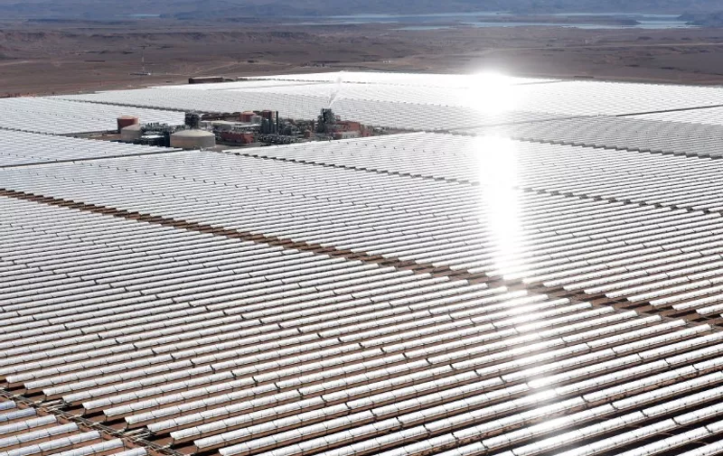 An aerial view of the solar mirrors at the Noor 1 Concentrated Solar Power (CSP) plant, some 20km (12.5 miles) outside the central Moroccan town of Ouarzazate on February 4, 2016. 
Noor 1 is one of the largest solar plants in the world, which is the first stage of a larger project designed to boost renewable energy production in Morocco. / AFP / FADEL SENNA