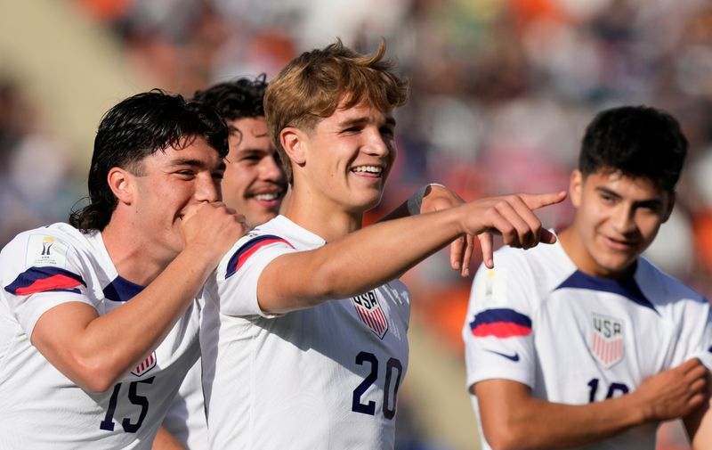 Rokas Pukstas (20) of the United States is congratulated after scoring his side's 4th goal against New Zealand during a FIFA U-20 World Cup round of 16 soccer match at the Malvinas Argentinas stadium in Mendoza, Argentina, Tuesday, May 30, 2023. (AP Photo/Natacha Pisarenko)