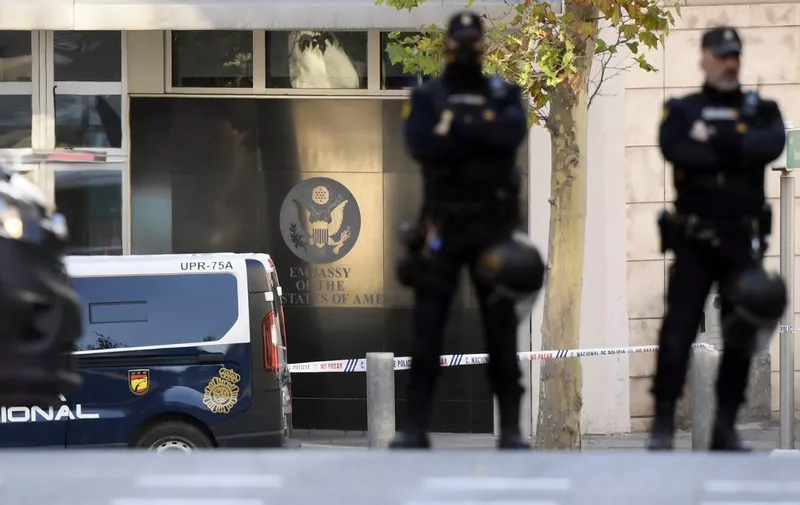 Spanish police stand guard near the US embassy in Madrid, on December 1, 2022, after they have received a letter bomb, similar to one which went off at the Ukrainian embassy. (Photo by OSCAR DEL POZO / AFP)