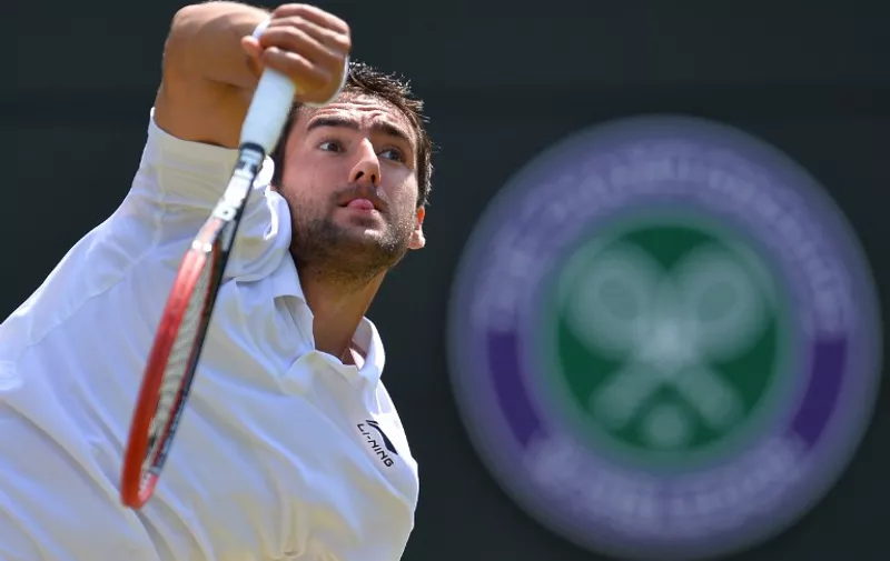 Croatia's Marin Cilic serves against US player John Isner during their men's singles third round match on day six of the 2015 Wimbledon Championships at The All England Tennis Club in Wimbledon, southwest London, on July 4, 2015.   RESTRICTED TO EDITORIAL USE  --  AFP PHOTO / GLYN KIRK