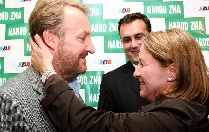 Bosnian Muslim candidate for Bosnia's tripartite Presidency, Bakir Izetbegovic (L), is congratulated by his wife Sebija Izetbegovic (R)  following the general elections, in Sarajevo, early October 4, 2010. General Bosnia's election resultsshowed moderates gaining ground in central government, but hardliners stayed firmly entrenched in the Serb entity, casting a shadow over the country's European future. Moderate Bakir Izetbegovic was set to secure the main Muslim seat in Bosnia's tripartite presidency after Sunday's vote. AFP PHOTO ELVIS BARUKCIC (Photo by ELVIS BARUKCIC / AFP)