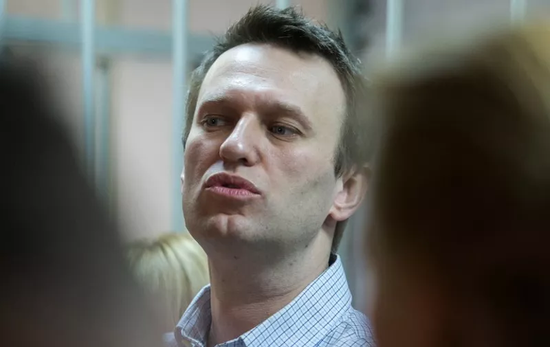 Russian anti-Kremlin opposition leader Alexei Navalny speaks as he attends the verdict announcement of his fraud trial at a court in Moscow on December 30, 2014. Russia's top opposition leader Alexei Navalny on December 30 called for mass protests to "destroy" President Vladimir Putin's regime after a court handed him a suspended sentence but jailed his brother in a controversial fraud case. In a lightning hearing that was abruptly brought forward by two weeks, a judge found both Navalny and his brother Oleg guilty of embezzlement and sentenced the siblings to three and a half years in what is widely seen as a politically motivated case. AFP PHOTO / DMITRY SEREBRYAKOV / AFP PHOTO / DMITRY SEREBRYAKOV