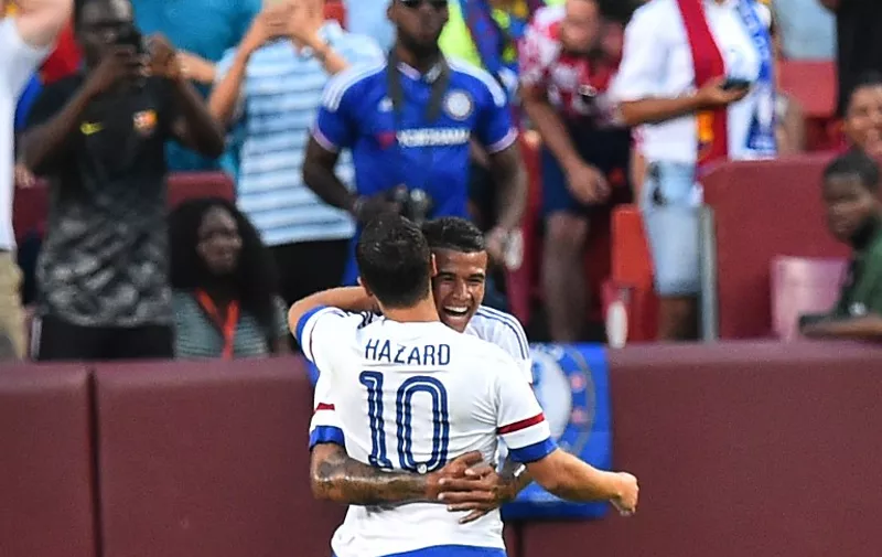Chelsea's Eden Hazard celebrates with Kenedy after scoring against Barcelona during an International Champions Cup football match in Landover, Maryland, on July 28, 2015.    AFP PHOTO/NICHOLAS KAMM