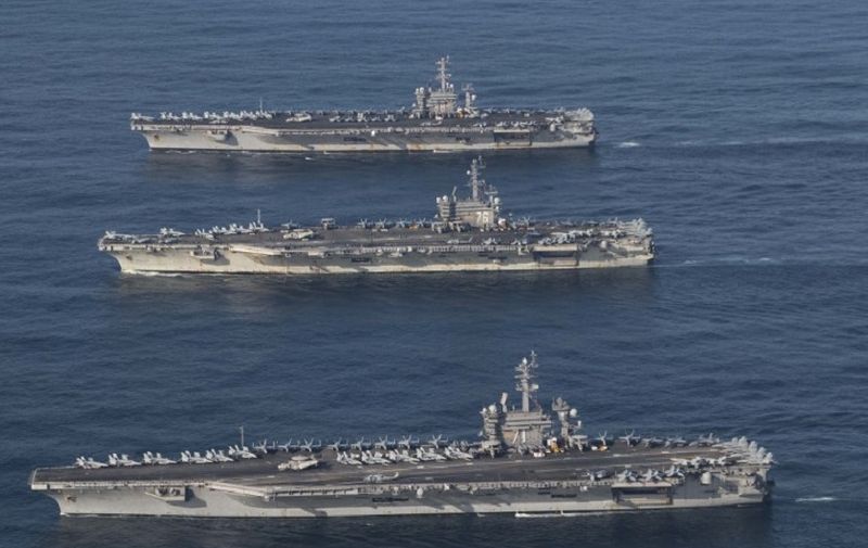 This image released by the US Navy on November 12, 2017, shows the aircraft carriers USS Ronald Reagan (C), USS Theodore Roosevelt (bottom) and USS Nimitz (top) and their strike groups are underway, conducting operations, in international waters as part of a three-carrier strike force exercise. 
The strike groups are underway, and conducting operations, in international waters as part of a three-carrier strike force exercise. / AFP PHOTO / US NAVY / James GRIFFIN / RESTRICTED TO EDITORIAL USE - MANDATORY CREDIT "AFP PHOTO / US NAVY / Lt. j.g. James GRIFFIN" - NO MARKETING NO ADVERTISING CAMPAIGNS - DISTRIBUTED AS A SERVICE TO CLIENTS
