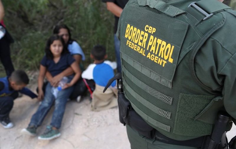 MCALLEN, TX - JUNE 12: Central American asylum seekers wait as U.S. Border Patrol agents take them into custody on June 12, 2018 near McAllen, Texas. The families were then sent to a U.S. Customs and Border Protection (CBP) processing center for possible separation. U.S. border authorities are executing the Trump administration's "zero tolerance" policy towards undocumented immigrants. U.S. Attorney General Jeff Sessions also said that domestic and gang violence in immigrants' country of origin would no longer qualify them for political asylum status.   John Moore/Getty Images/AFP