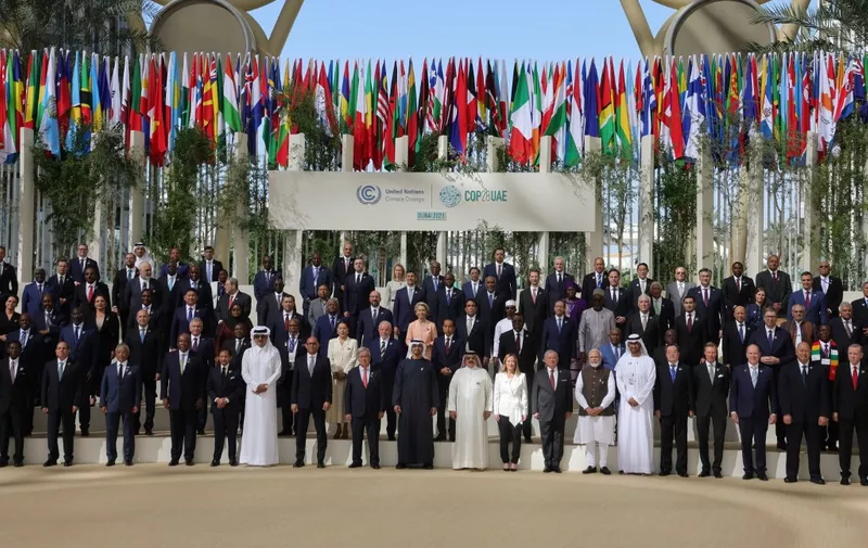 Participating world leaders and delegates pose for a family photo during the COP28 United Nations climate summit in Dubai on December 1, 2023. World leaders take centre stage at UN climate talks in Dubai on December 1, under pressure to step up efforts to limit global warming as the Israel-Hamas conflict casts a shadow over the summit. (Photo by Giuseppe CACACE / AFP)