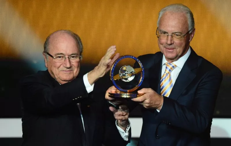 German footballing legend Franz Beckenbauer (R) receives the Presidential award from FIFA President Joseph Blatter during the FIFA Ballon d'Or awards ceremony at the Kongresshaus in Zurich on January 7, 2013.  AFP PHOTO / OLIVIER MORIN