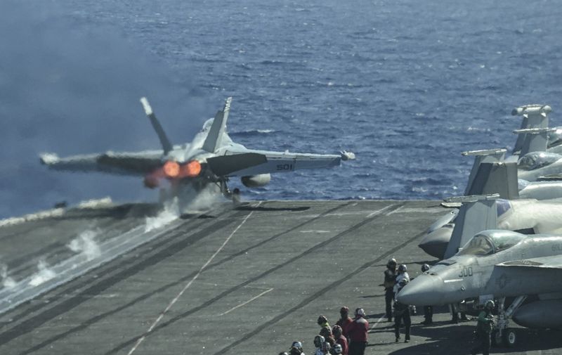 An F/A-18 fighter jet takes off from the deck of the USS Carl Vinson aircraft carrier during a three-day maritime exercise between the US and Japan in the Philippine Sea on January 31, 2024. (Photo by Richard A. Brooks / AFP) / The erroneous mention[s] appearing in the metadata of this photo by Richard A. Brooks has been modified in AFP systems in the following manner: clarifying to remove reference to Okinawa and Taiwan. Please immediately remove the erroneous mention[s] from all your online services and delete it (them) from your servers. If you have been authorized by AFP to distribute it (them) to third parties, please ensure that the same actions are carried out by them. Failure to promptly comply with these instructions will entail liability on your part for any continued or post notification usage. Therefore we thank you very much for all your attention and prompt action. We are sorry for the inconvenience this notification may cause and remain at your disposal for any further information you may require.