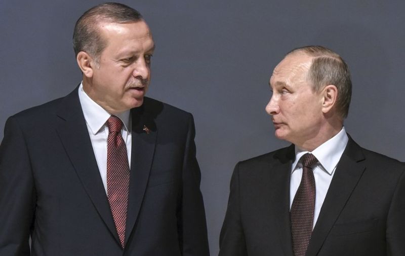 (FILES) This file photo taken on October 10, 2016 shows Russian President Vladimir Putin (R) listening to Turkish President Recep Tayyip Erdogan during the 23rd World Energy Congress in Istanbul.
It had seemed impossible to find insults more scathing.Russian President Vladimir Putin accused Turkish counterpart Recep Tayyip Erdogan of trading oil with Islamic State jihadists and making modern Turkey's founder Ataturk "roll in his grave".In a loud slanging match between two masters of political machismo, Erdogan in turn condemned Putin for "war crimes" in Syria.But a year after the start of the worst Turkey-Russia crisis sparked by the November 2015 shooting down of a Russian warplane by Turkish forces, Erdogan and Putin have this year resumed an increasingly tight relationship that has ruffled the West. 
 / AFP PHOTO / OZAN KOSE