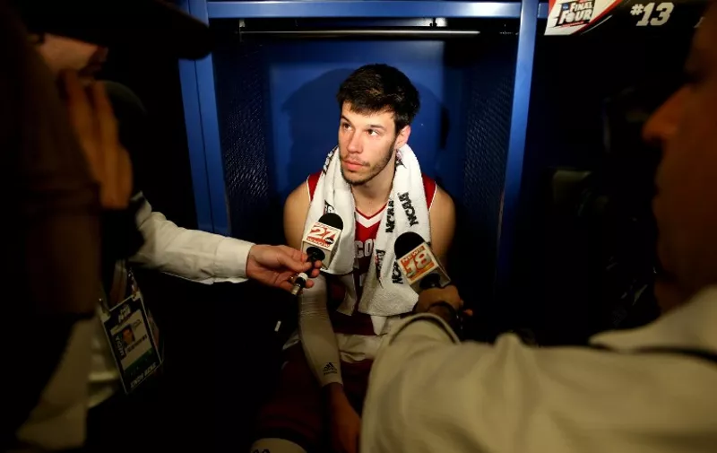 INDIANAPOLIS, IN - APRIL 06: Duje Dukan #13 of the Wisconsin Badgers speaks to media in the locker room after being defeated by the Duke Blue Devils during the NCAA Men's Final Four National Championship at Lucas Oil Stadium on April 6, 2015 in Indianapolis, Indiana. Duke defeated Wisconsin 68-63.   Andy Lyons/Getty Images/AFP