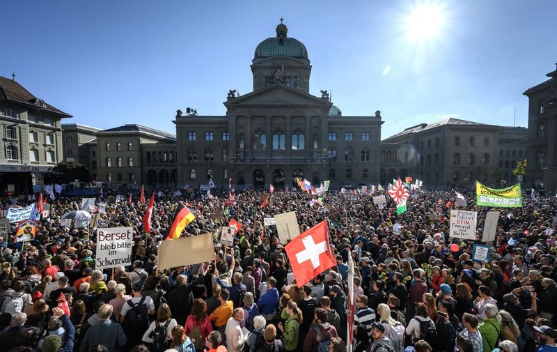 Thousands of protesters gather in front of the Swiss House of Parliament during a rally in opposition with the current measures to tackle the spread of the coronavirus, Covid-19 health pass and vaccination, in Bern on October 23, 2021. - On November 28, 2021, Swiss will vote on challenging the law underpinning many of the governments coronavirus measures. The countrys vaccination rate is lower than many other European nations. (Photo by Fabrice COFFRINI / AFP) / The erroneous mention[s] appearing in the metadata of this photo by Fabrice COFFRINI has been modified in AFP systems in the following manner: [Bern] instead of [Lausanne]. Please immediately remove the erroneous mention[s] from all your online services and delete it (them) from your servers. If you have been authorized by AFP to distribute it (them) to third parties, please ensure that the same actions are carried out by them. Failure to promptly comply with these instructions will entail liability on your part for any continued or post notification usage. Therefore we thank you very much for all your attention and prompt action. We are sorry for the inconvenience this notification may cause and remain at your disposal for any further information you may require.
