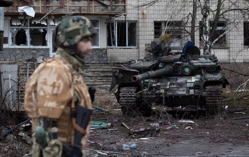 Ukrainian soldiers walk next to a Ukrainian tank around the bridge separating Irpin and Bucha after clashes between the Ukrainian and Russian Army in Irpin town, amid Russian invasion of Ukraine, outside of Kyiv, Ukraine April 2, 2022.,Image: 677319904, License: Rights-managed, Restrictions: , Model Release: no, Credit line: Profimedia
