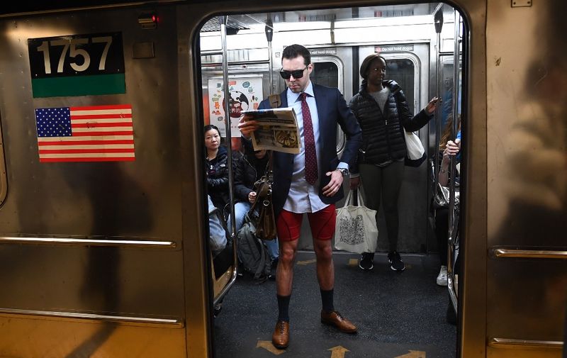 Participants in the 19th Annual "No Pants Subway Ride" travel in the subway on January 12, 2020 in New York. - The "No Pants Subway Ride" is an annual event started in 2002 by Improv Everywhere in New York, the goal of which is for subway riders to dress in normal winter clothes without pants while keeping a straight face. (Photo by Johannes EISELE / AFP)