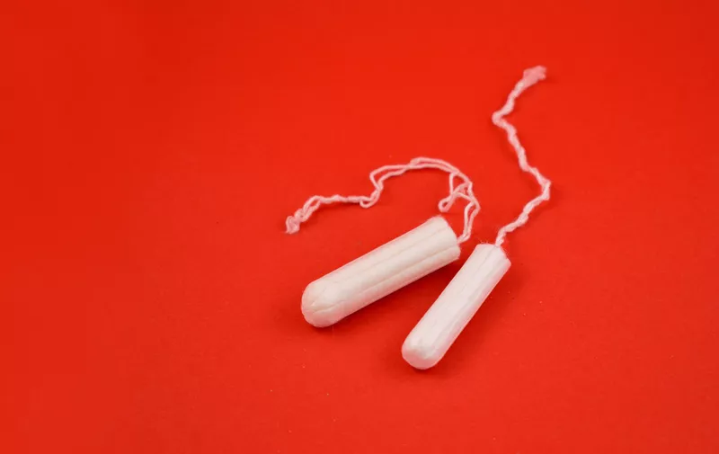 Feminine hygiene product. White tampons on a red background. Tampons for women