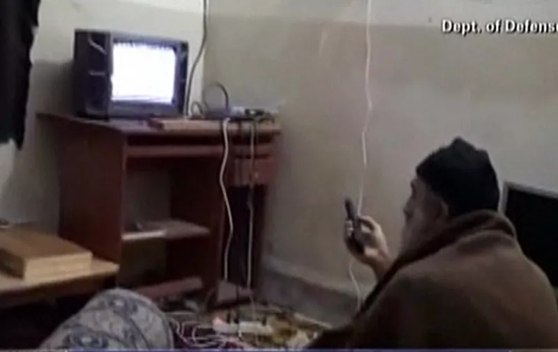 (FILES) This framegrab from an undated video released by the US Department of DefenCe on May 7, 2011, reportedly shows Al-Qaeda leader Osama bin Laden watching television at his compound in Abbottabad, Pakistan. The CIA declassified an Al-Qaeda recruitment form and around 100 other documents from Bin Laden's archive on May 20, 2015, allowing an insight into his thinking in his final years. The documents were among intelligence materials seized by US commandos on May 2, 2011 after they stormed Bin Laden's hideout in the Pakistani town of Abbottabad and shot him dead.  AFP PHOTO / US Department of Defence