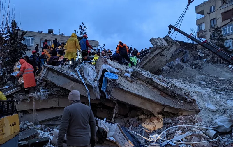 Rescue workers and volunteers search for survivors in the rubble of a collasped building, in Sanliurfa, Turkey, on February 6, 2023, after a 7.8-magnitude earthquake struck the country's south-east. - The combined death toll has risen to over 2,300 for Turkey and Syria after the region's strongest quake in nearly a century. Turkey's emergency services said at least 1,121 people died in the earthquake, with another 783 confirmed fatalities in Syria. (Photo by REMI BANET / AFP)