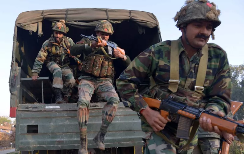Indian army personnel leap from the rear of a truck at an airforce base in Pathankot on January 3, 2016, during an operation to 'sanitise' the base following an attack by gunmen.  The deadly assault on an Indian air base near the Pakistan border was "a heinous" terrorist attack, the United States said, urging the two rivals to work together to hunt down those responsible. Three security officers were killed in the attack by suspected Islamist militants on Pathankot base in northern Punjab state early January 2. At least four attackers also died in shootouts with security forces.   AFP PHOTO/NARINDER NANU / AFP / NARINDER NANU